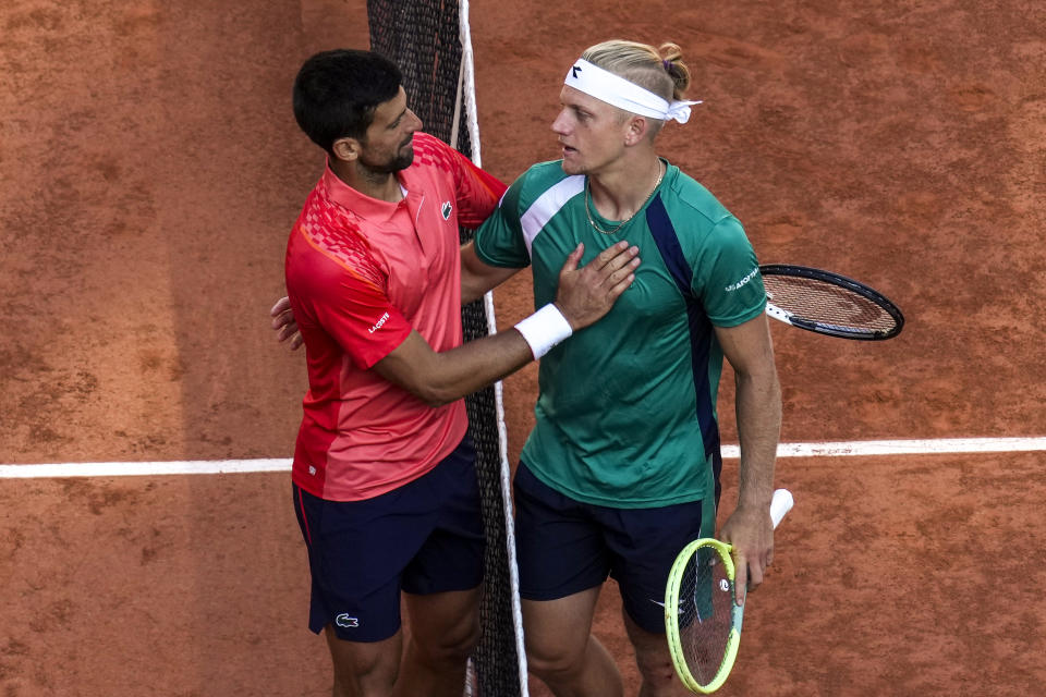Serbia's Novak Djokovic is congratulated by Spain's Alejandro Davidovich Fokina, right, after he won the third round match of the French Open tennis tournament in three sets, 7-6 (7-4), 7-6 (7-5), 6-2, at the Roland Garros stadium in Paris, Friday, June 2, 2023. (AP Photo/Christophe Ena)
