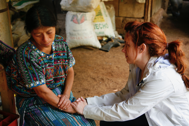 Romina Ruiz-Goiriena comforts a mother who lost her son while on assignment in Guatemala for the Associated Press in 2012. Photo taken by Moises Castillo.