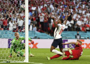 England's Raheem Sterling, center, falls down as Denmark's Simon Kjaer, right, scores an own goal past Denmark's goalkeeper Kasper Schmeichel during the Euro 2020 soccer championship semifinal match between England and Denmark at Wembley Stadium in London, Wednesday, July 7, 2021. (Andy Rain/Pool via AP)