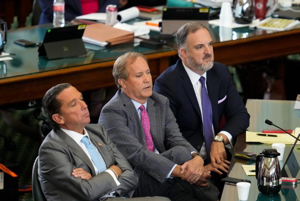 Attorney General Ken Paxton sits between his attorneys Tony Buzbee, left, and Mitch Little, right, during final prosecutor arguments as both sides have rested in the suspended Attorney General's impeachment trial September 15, 2023 in Austin.