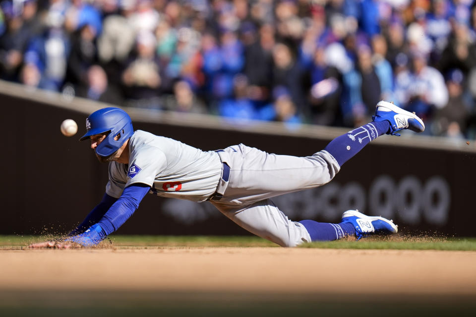 Los Angeles Dodgers' Chris Taylor dives to second base on a wild pitch by Chicago Cubs pitcher Julian Merryweather during the eighth inning of a baseball game Friday, April 5, 2024, in Chicago. (AP Photo/Erin Hooley)