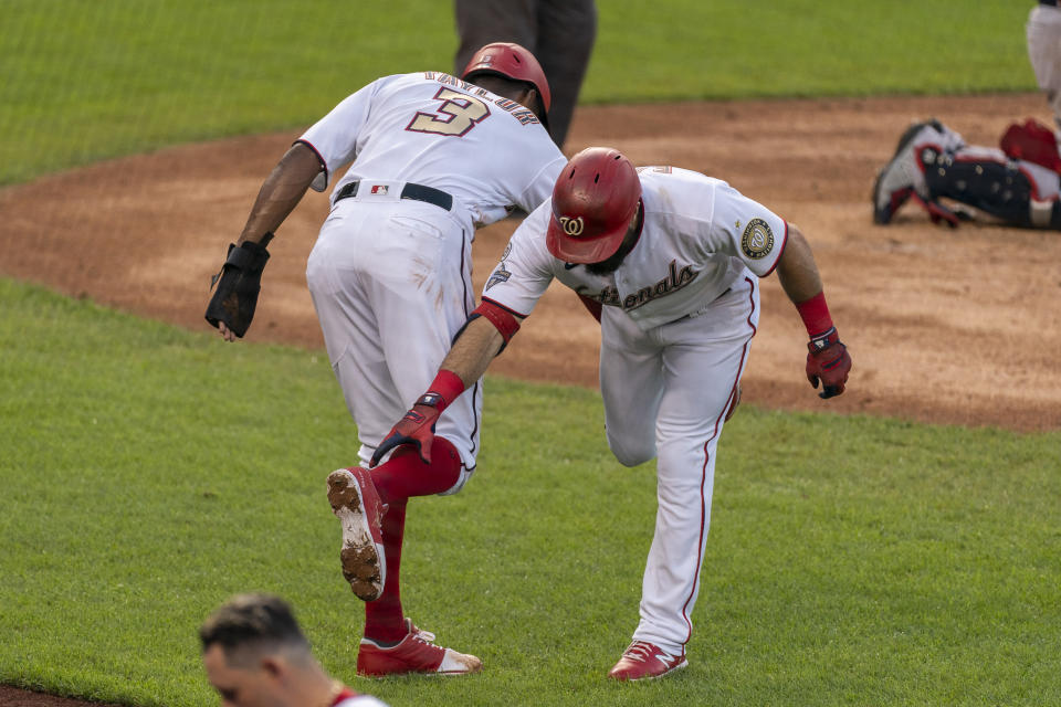 Washington Nationals' Adam Eaton is congratulated by teammate Michael A. Taylor (3) after hitting a two-run home run during the second inning of a baseball game in Washington, Thursday, Sept. 10, 2020. (AP Photo/Manuel Balce Ceneta)