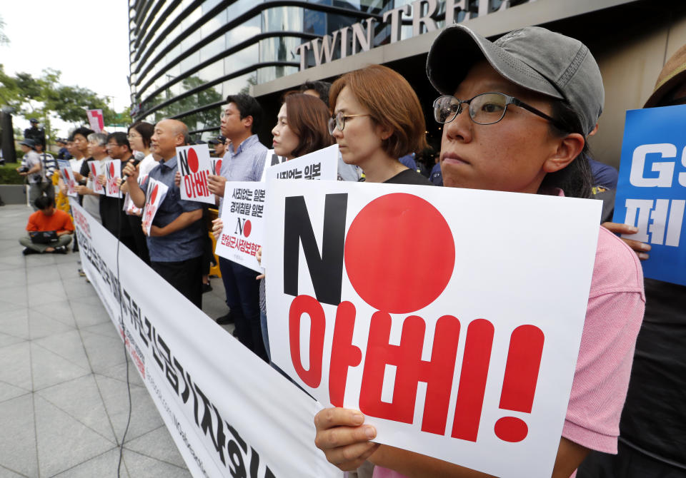 South Korean protesters stage a rally against Japan in front of a building which houses Japanese embassy in Seoul, South Korea, Friday, Aug. 2, 2019. Japan's Cabinet on Friday approved the removal of South Korea from a "whitelist" of countries with preferential trade status, a move sure to fuel antagonism already at a boiling point over recent export controls and the issue of compensation for wartime Korean laborers. The signs read " Japanese Prime Minister Shinzo Abe." (AP Photo/Ahn Young-joon)