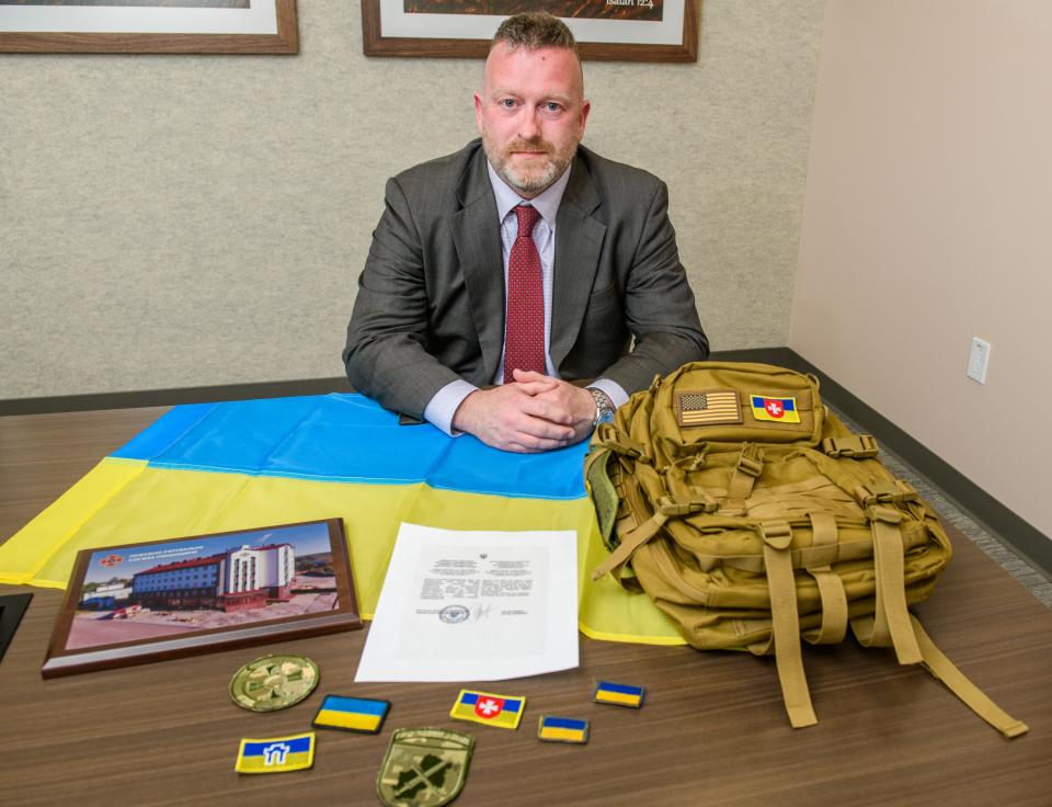 OSF HealthCare vice president of government relations Chris Manson shows some of the items he collected during his recent trip to Ukraine. Manson organized the delivery of an AMT ambulance filled with medical supplies to the war-torn nation.