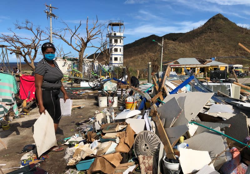 Naeeth Novaglia, 32, collects some debris from her home that was destroyed by the passage of Storm Iota