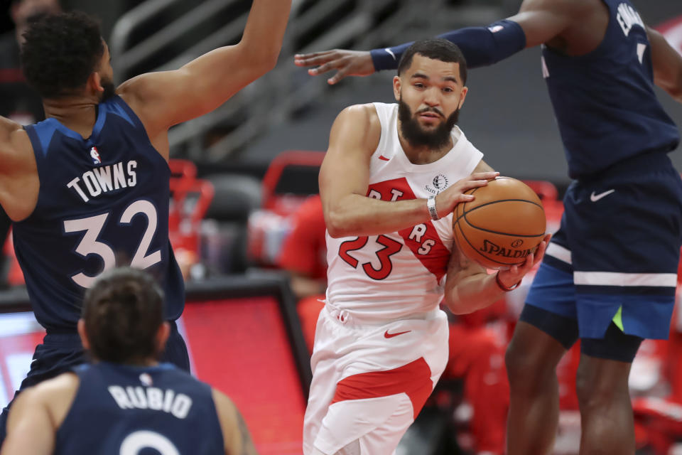 Toronto Raptors' Fred VanVleet drives against Minnesota Timberwolves' Karl-Anthony Towns during the first half of an NBA basketball game Sunday, Feb. 14, 2021, in Tampa, Fla. (AP Photo/Mike Carlson)