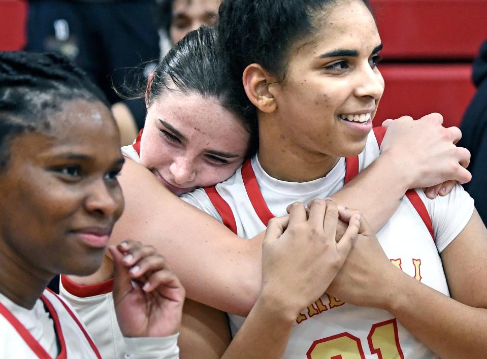 Cardinal Mooney's Sy' Monique Simon (#15), Sam Kotasek (#32), and Kali Barrett (#21) celebrating a 64-40 victory over visiting Tampa Catholic on Thursday evening, Feb.22, 2024, winning the Class 3A-Region 3 final at Patterson Pavilion in Sarasota.