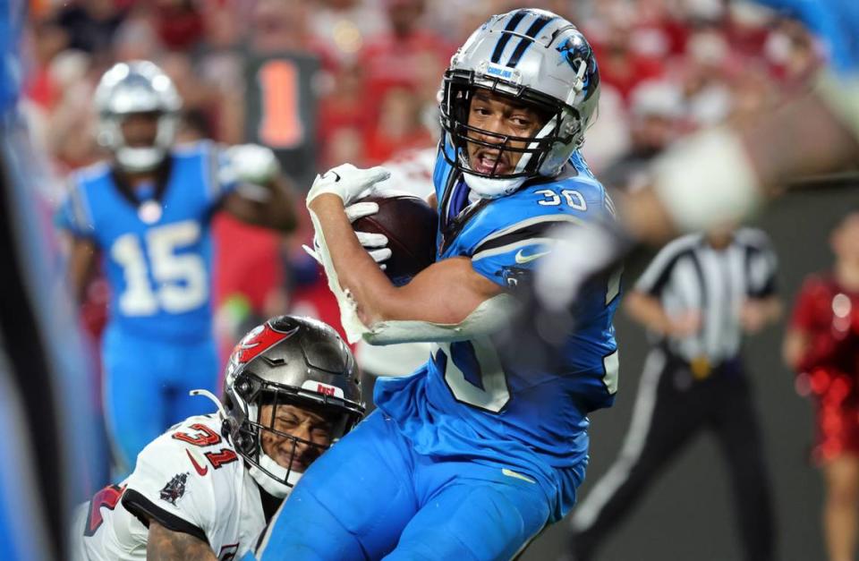 Dec 3, 2023; Tampa, Florida, USA; Carolina Panthers running back Chuba Hubbard (30) runs with the ball as Tampa Bay Buccaneers safety Antoine Winfield Jr. (31) defends during the second half at Raymond James Stadium. Mandatory Credit: Kim Klement Neitzel-USA TODAY Sports