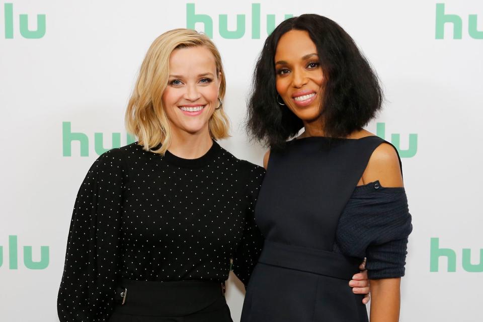 <p>Rachel Murray/Getty</p> Reese Witherspoon and Kerry Washington pose at the Hulu Panel in 2020.