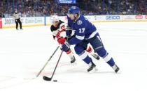 Nov 25, 2018; Tampa, FL, USA; Tampa Bay Lightning left wing Alex Killorn (17) skates with he puck as New Jersey Devils center Travis Zajac (19) defends during the first period at Amalie Arena. Mandatory Credit: Kim Klement-USA TODAY Sports