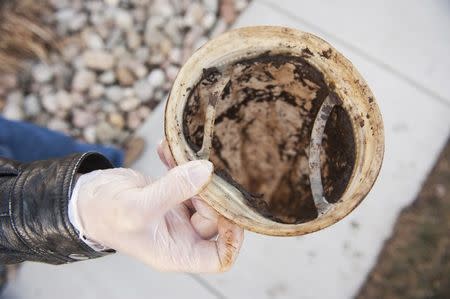 An environmental group employee holds a used filter sock in Bismarck, North Dakota January 27, 2015. REUTERS/Andrew Cullen