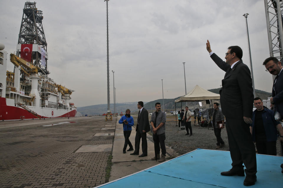 Turkish Energy and Natural Resources Minister Fatih Donmez waves to members of the crew of the 230-meter (750-foot) drilling ship 'Yavuz' scheduled to be dispatched to the Mediterranean, following a ceremony, at the port of Dilovasi, outside Istanbul, Thursday, June 20, 2019. Turkish officials say the drillship Yavuz will be dispatched to an area off Cyprus to drill for gas. The Cyprus government says Turkey’s actions contravene international law and violate Cypriot sovereign rights. (AP Photo/Lefteris Pitarakis)