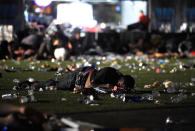 <p>A person lies on the ground at the Route 91 Harvest country music festival after apparent gun fire was heard on Oct. 1, 2017 in Las Vegas, Nevada. There are reports of an active shooter around the Mandalay Bay Resort and Casino. (Photo: David Becker/Getty Images) </p>