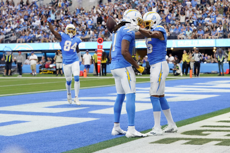 Los Angeles Chargers wide receiver Jalen Guyton (15) celebrates his touchdown catch with wide receiver Quentin Johnston (1) during the second half an NFL football game against the Detroit Lions Sunday, Nov. 12, 2023, in Inglewood, Calif. (AP Photo/Gregory Bull)