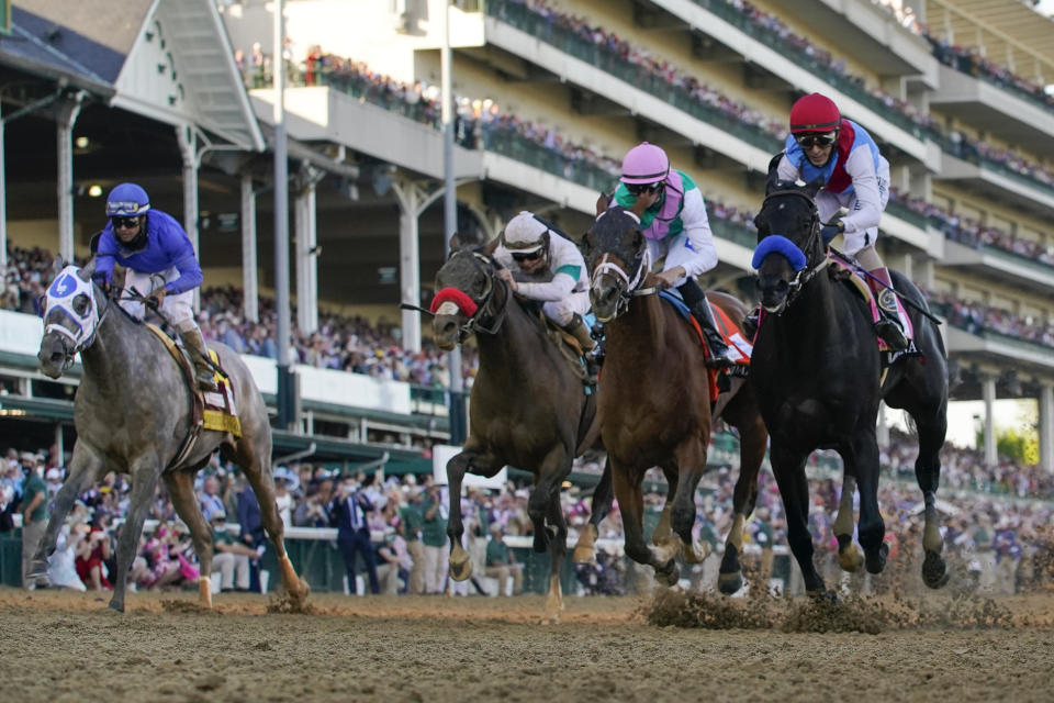 FILE - John Velazquez riding Medina Spirit, right, leads Florent Geroux on Mandaloun, Flavien Prat riding Hot Rod Charlie and Luis Saez on Essential Quality to win the 147th running of the Kentucky Derby at Churchill Downs in Louisville, Ky., Saturday, May 1, 2021. Medina Spirit was stripped of the victory in last year’s Kentucky Derby and Mandaloun was declared the winner in a ruling by state racing stewards on Monday, Feb. 21, 2022. (AP Photo/Jeff Roberson, File)