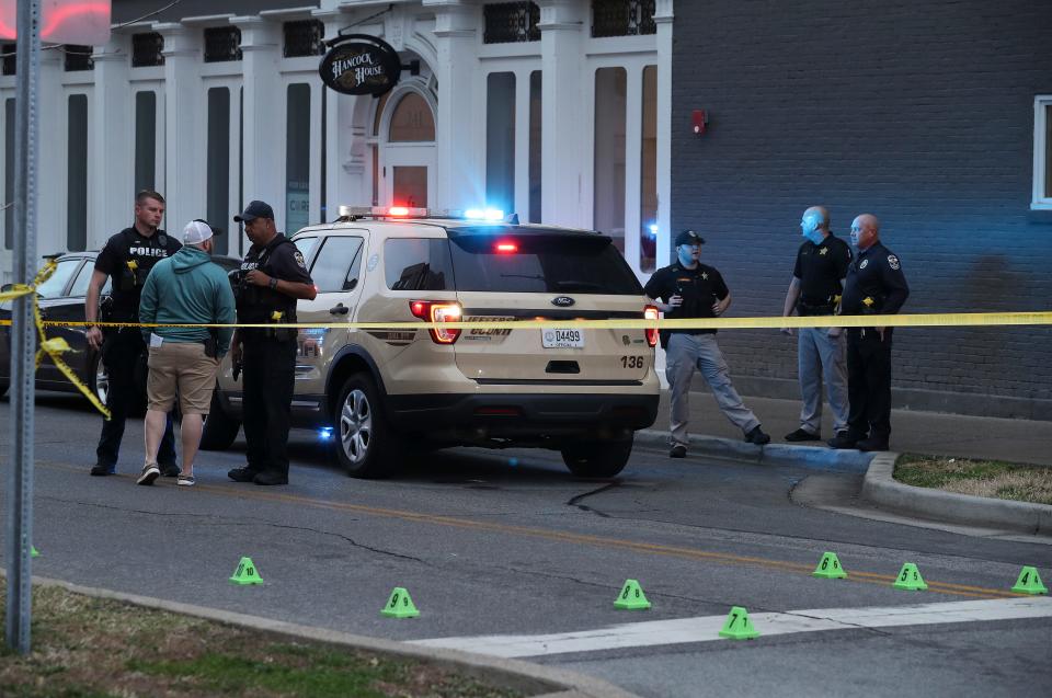 The LMPD investigate the scene where four people were shot at the Seafood Lady restaurant in the NuLu district of Louisville, Ky. on Mar. 6, 2022.  