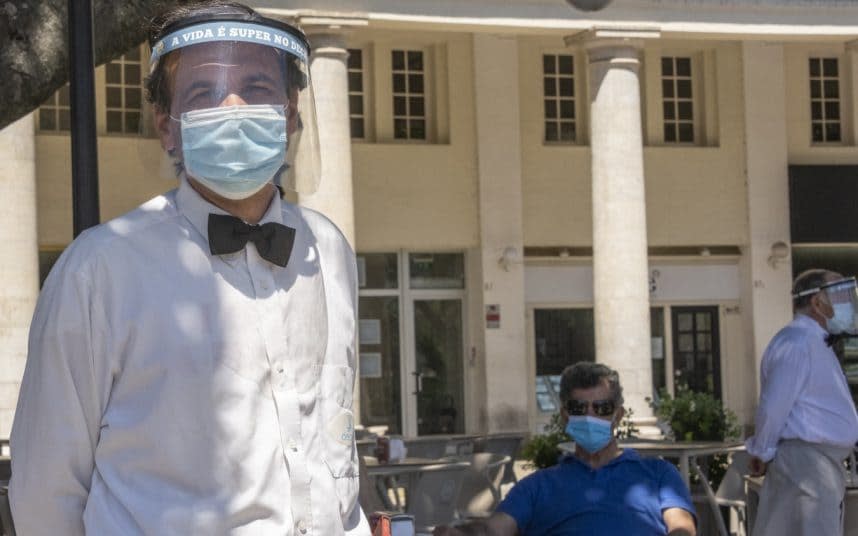 Staff and customers at the Deck beer garden in Estoril, near Lisbon, wear protective masks as more businesses reopen in Portugal - HORACIO VILLALOBOS/GETTY