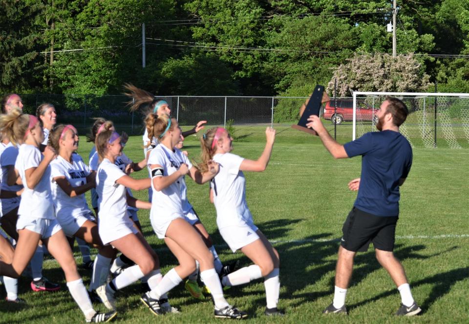 Gull Lake coach Colton Johnson presents the district championship trophy to his team following a win over No. 1 Marshall in the Division 2 finals on Friday at Marshall High School.