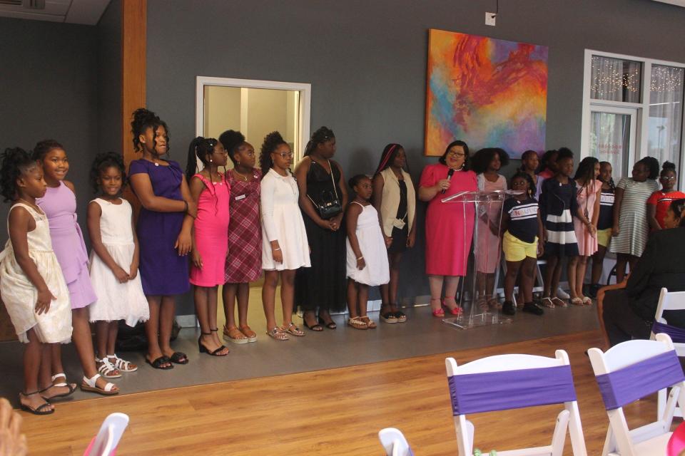 Susan McClellan, holding the microphone, thanked the girls in the Concrete Rose Foundation for their participation.
(Credit: Photo by Voleer Thomas/For The Guardian)