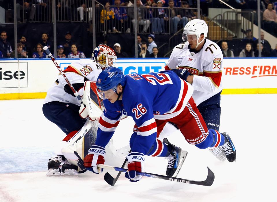 NEW YORK, NEW YORK - MARCH 04: Niko Mikkola #77 of the Florida Panthers checks Jimmy Vesey #26 of the New York Rangers during the second period at Madison Square Garden on March 04, 2024 in New York City.