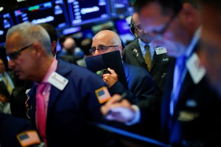 Traders work on the floor at the New York Stock Exchange (NYSE) in New York