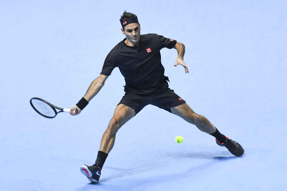 Roger Federer of Switzerland returns to Novak Djokovic of Serbia during their ATP World Tour Finals singles tennis match at the O2 Arena in London, Thursday, Nov. 14, 2019. (AP Photo/Alberto Pezzali)