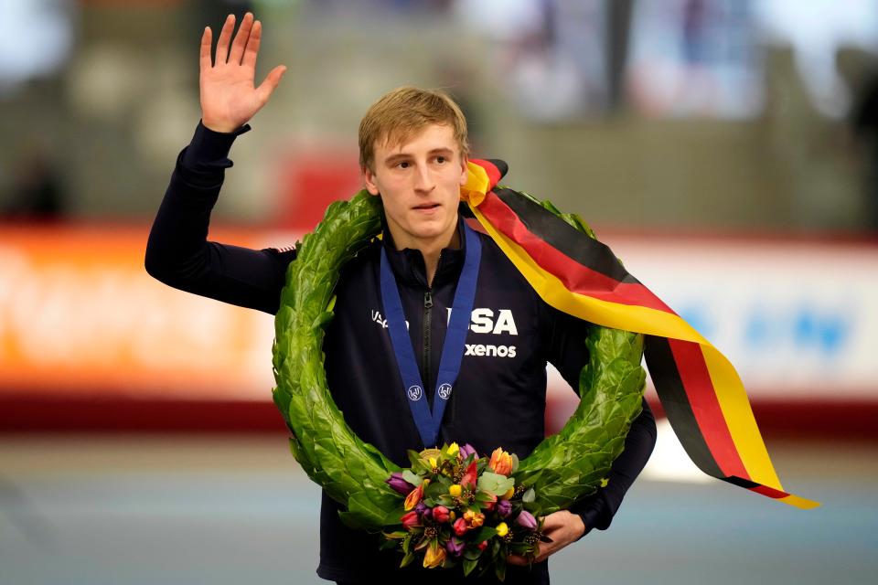 Jordan Stolz of Kewaskum waves to the crowd as he celebrates after winning world allround title Sunday in Inzell, Germany.