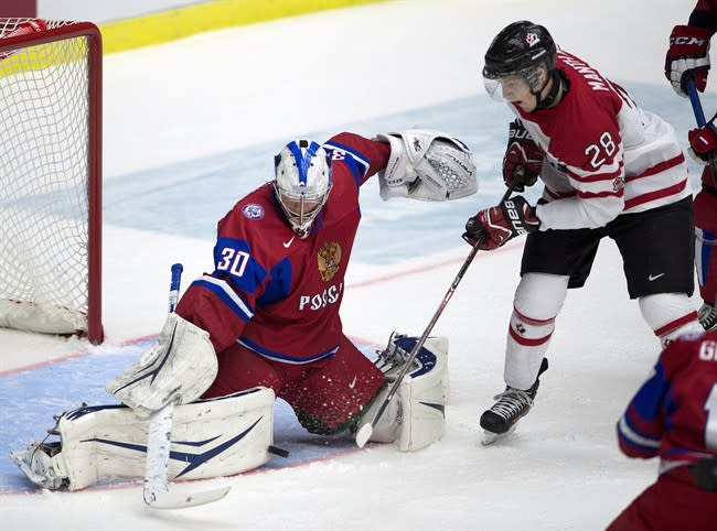 Russia goaltender Andrei Vasilevski makes a save on Canada forward Anthony Mantha duirng first period bronze medal game action at the IIHF World Junior Hockey Championships in Malmo, Sweden on Sunday, January 5, 2014. THE CANADIAN PRESS/ Frank Gunn