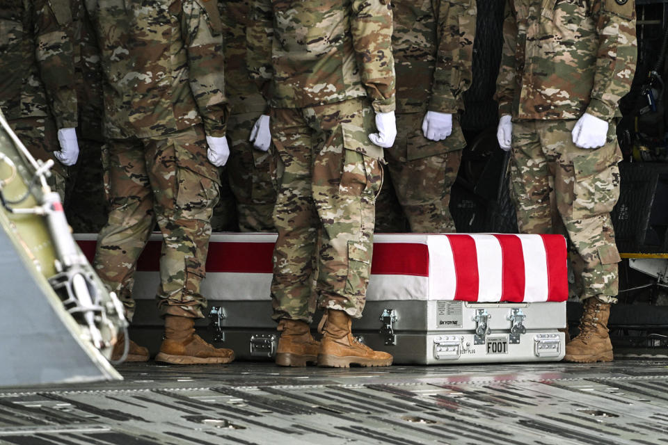 Image: A transfer case is unloaded during the dignified transfer ceremony  (Roberto Schmidt / AFP - Getty Images)