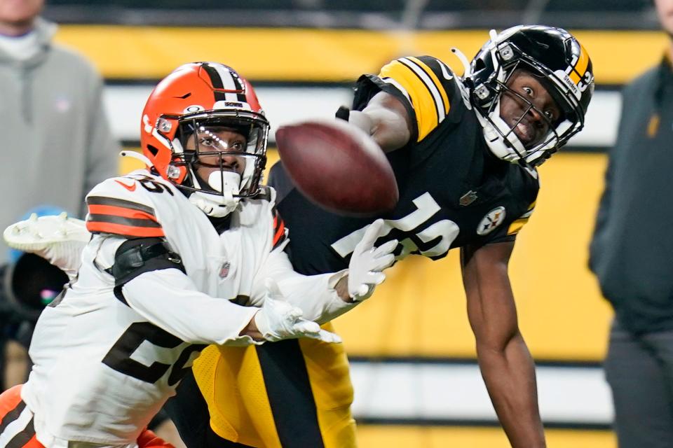 The ball gets past Pittsburgh Steelers wide receiver James Washington (13) and Cleveland Browns cornerback Greedy Williams (26) during the first half an NFL football game, Monday, Jan. 3, 2022, in Pittsburgh. (AP Photo/Gene J. Puskar)