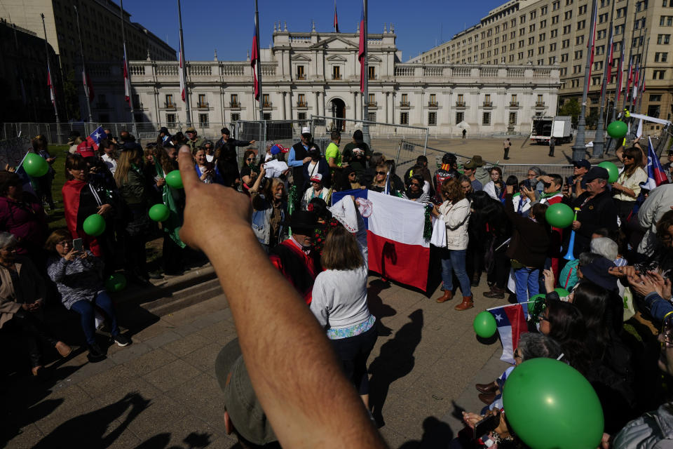 People take part in a demonstration seeking justice for police officers killed in the line of duty, in front of the La Moneda presidential palace in Santiago, Chile, Saturday, April 27, 2024. Three police officers were killed early Saturday, in Cañete, Chile's Bío Bío region. (AP Photo/Esteban Felix)