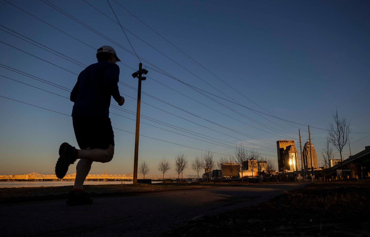 A runner jogs along the Waterfront Park Phase IV, which connects Portland and the West End to the downtown via a paved path along the Ohio River. February 2019