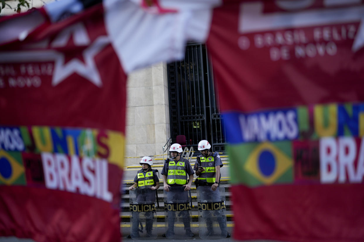 Police stand guarding a street after the closing of the polls for a presidential run-off election in Sao Paulo, Brazil, Sunday, Oct. 30, 2022.(AP Photo/Matias Delacroix)