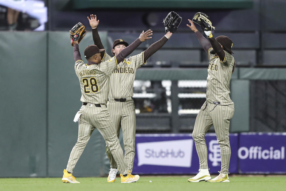 San Diego Padres' Jose Azocar (28), Jackson Merrill, center, and Fernando Tatis Jr. celebrate after a win against the San Francisco Giants in a baseball game in San Francisco, Saturday, April 6, 2024. (AP Photo/Kavin Mistry)