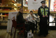 <p>A policeman sits with a couple of shoppers in a coffee shop in Regent Street in central London on Nov. 24, 2017, as police responded to an incident. (Photo: Daniel Leal-Olivas/AFP/Getty Images) </p>