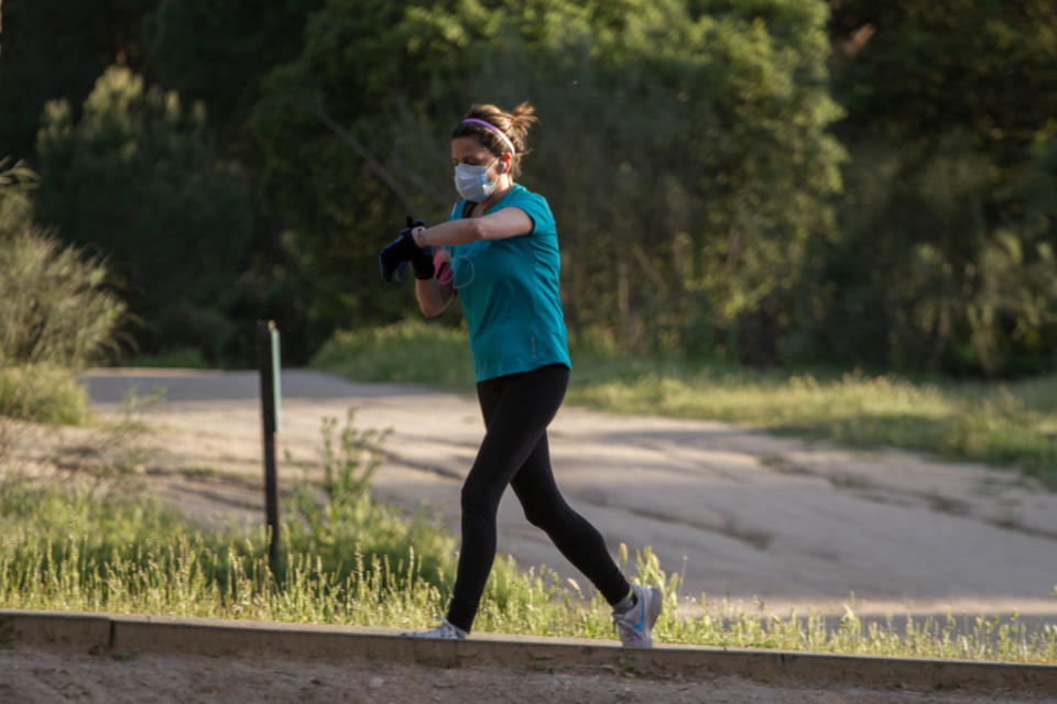 MAJADAHONDA, MADRID, SPAIN - MAY 2. A young woman jogs on the paths and trails near Monte del Pilar shortly after 8 pm on May 2, 2020, in Majadahonda, Madrid, Spain.  Spain continues to ease the Covid-19 lockdown measures this weekend, with high temperatures forecast across the country. Permitted activities now include walking with the family, outdoor exercise such as running and going out with children. (Photo by Miguel Pereira/Getty Images)