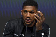 Britain's Anthony Joshua speaks during a press conference after his loss to Oleksandr Usyk of Ukraine in the WBA (Super), WBO and IBF boxing title bout at the Tottenham Hotspur Stadium in London Saturday Sept. 25, 2021. (Nick Potts/PA via AP)