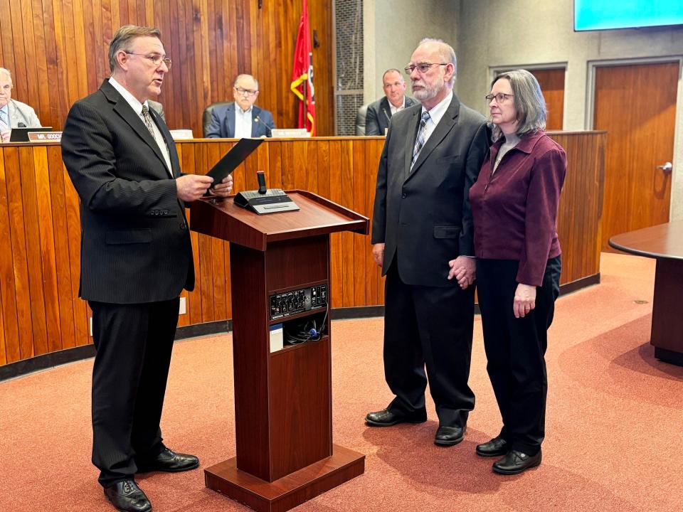 Oak Ridge City Manager Randy Hemann, from left, presents Jack Suggs, standing with his wife Joan, with a proclamation honoring him upon his retirement after 40 years of public service. He's worked as deputy city manager and Electric Department director for the city, as well as serving as interim city manager following Mark Watson's retirement.