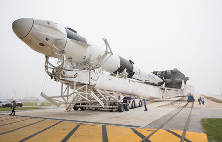 A SpaceX Falcon 9 rocket with the company's Crew Dragon spacecraft onboard is seen as it is rolled out of the horizontal integration facility at Launch Complex 39A as preparations continue for the Demo-1 mission at the Kennedy Space Center in Cape Canaveral, Florida, U.S., February 28, 2019. Joel Kowsky/NASA/Handout via REUTERS