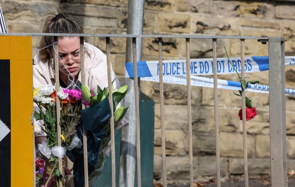 Floral tributes being left near the scene in Woodhouse Hill, Huddersfield (Nigel Roddis/PA) (PA Wire)