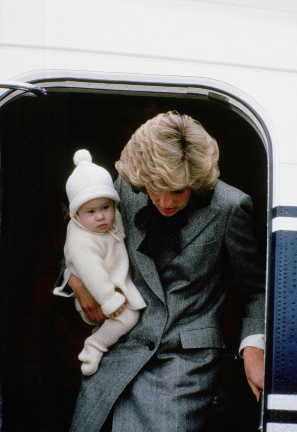 Diana, Princess of Wales carries her son, Prince Harry, off a flight at Aberdeen Airport  (Photo by Tim Graham/Getty Images)