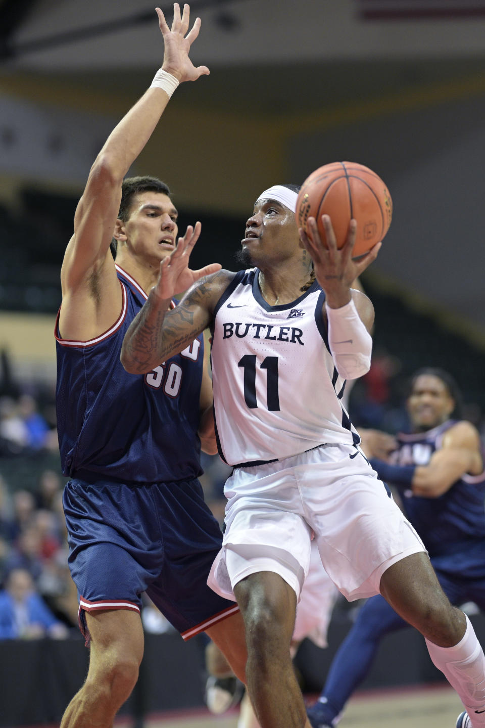 Butler guard Jahmyl Telfort (11) goes up for a shot while defended by Florida Atlantic center Vladislav Goldin (50) during the first half of an NCAA college basketball game, Thursday, Nov. 23, 2023, in Kissimmee, Fla. (AP Photo/Phelan M. Ebenhack)