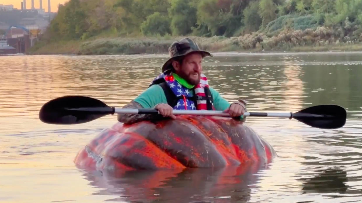  Man paddles Missouri River in giant pumpkin boat . 