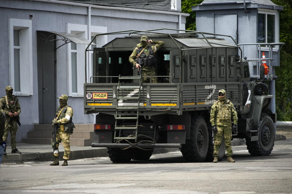 FILE - Russian soldiers guard an area as a group of foreign journalists visit in Kherson, Kherson region, south Ukraine, May 20, 2022. The southern city of Kherson was the first to fall to Russia's invasion. But Kherson remains at the heart of the conflict and Ukraine's efforts to save its vital access to the sea. This photo was taken during a trip organized by the Russian Ministry of Defense. (AP Photo, File)