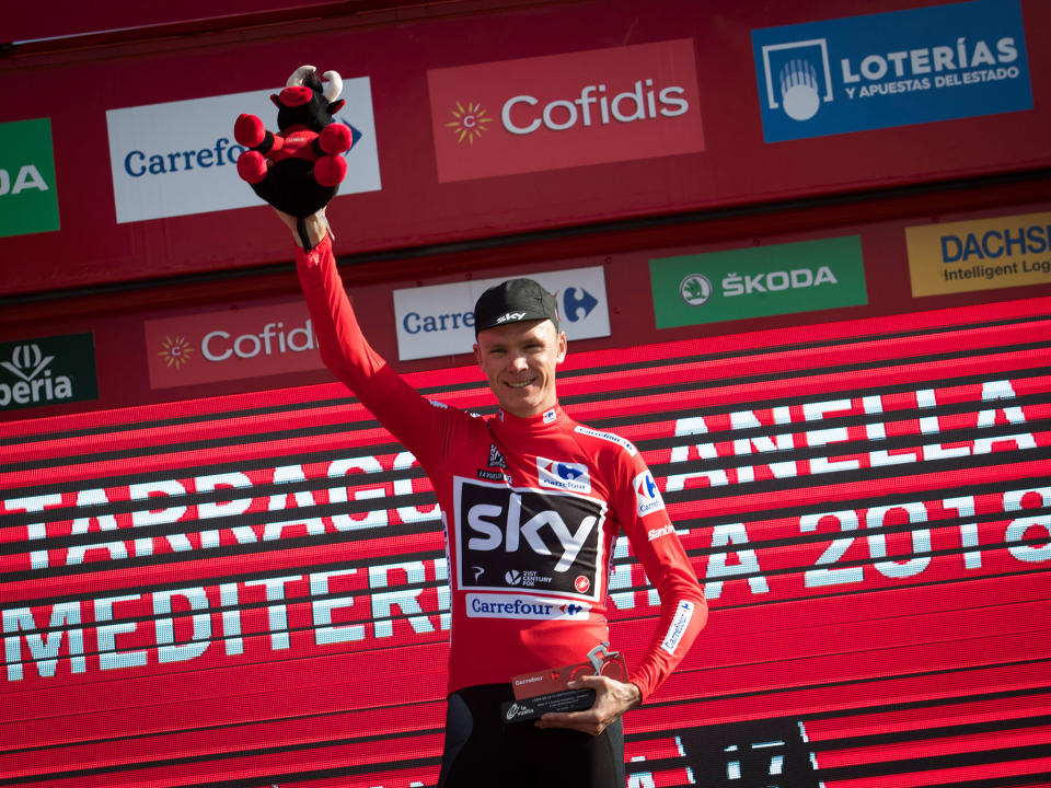 Chris Froome on the podium with the leader's red jersey: Getty