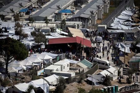 Refugees and migrants line up for food distribution at the Moria migrant camp on the island of Lesbos, Greece October 6, 2016. REUTERS/Alkis Konstantinidis/File Photo