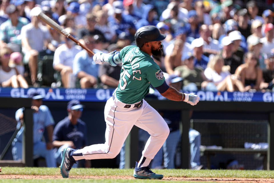 Seattle Mariners' Teoscar Hernandez follows through on a two-run double during the seventh inning of a baseball game against the Toronto Blue Jays, Saturday, July 22, 2023, in Seattle. (AP Photo/Jason Redmond)