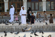 <p>People look at pigeons at Souq Waqif market in Doha, Qatar, June 6, 2017. (Photo: Naseem Zeitoon/Reuters) </p>