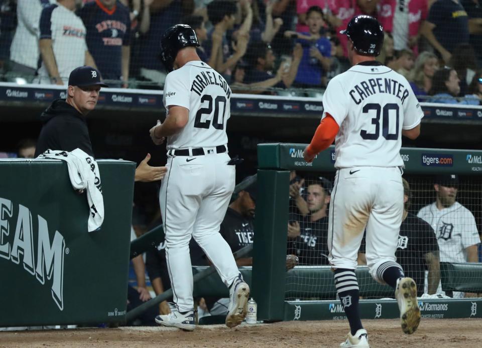Manager A.J. Hinch meets Spencer Torkelson (20) and Kerry Carpenter (30) after they scored against the Chicago Cubs during eighth-inning action at Comerica Park in Detroit on Monday, Aug. 21, 2023.