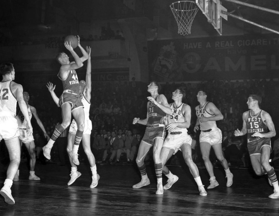 FILE - Jerry West (44) of West Virgina University shoots a jump shot against George Washington University during a Southern Conference game in Washington March 1, 1958. Others pictured include West Virginia's Lloyd Sharrar (31) and George Washington University's Gene Guarilia (54) and Howard McDonald (50). (AP Photo/Harvey Georges, File)